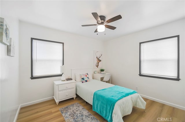 bedroom with light wood-type flooring and ceiling fan