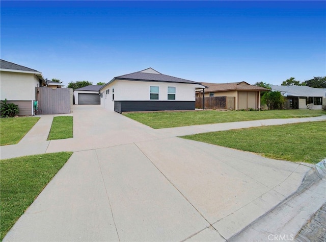 single story home with a front yard and a garage