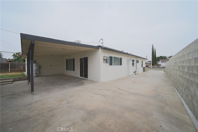 rear view of property with a carport