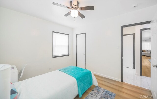 bedroom with ceiling fan and light hardwood / wood-style flooring