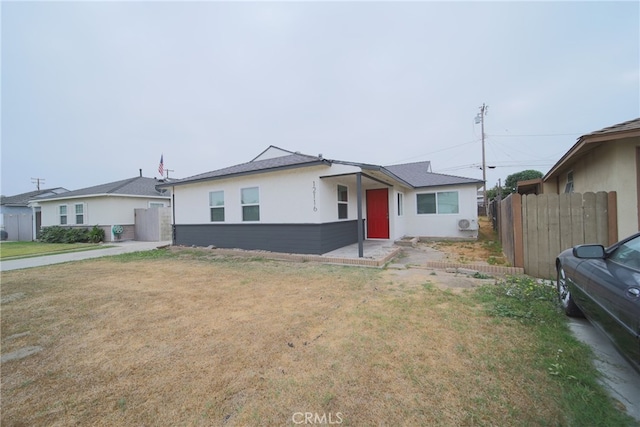 ranch-style home with a front lawn