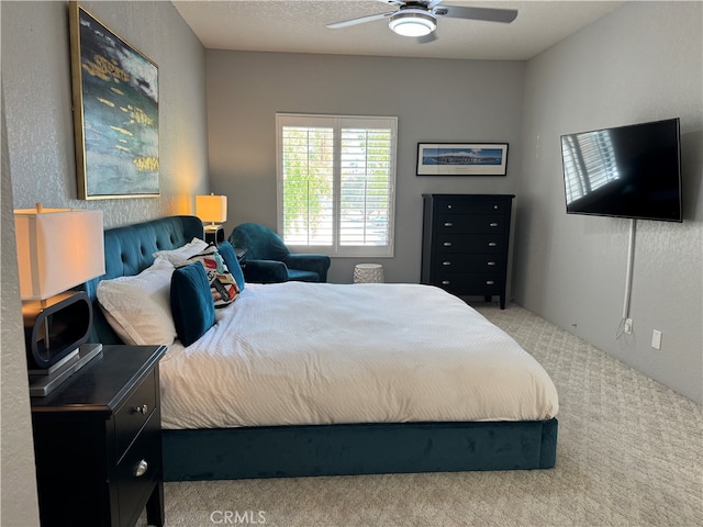 bedroom with light carpet and ceiling fan