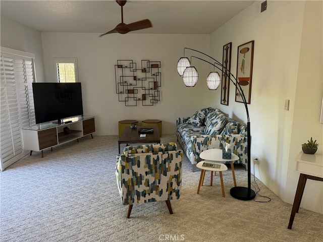 carpeted living room featuring ceiling fan