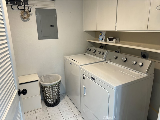 laundry room with independent washer and dryer, light tile patterned flooring, cabinets, and electric panel