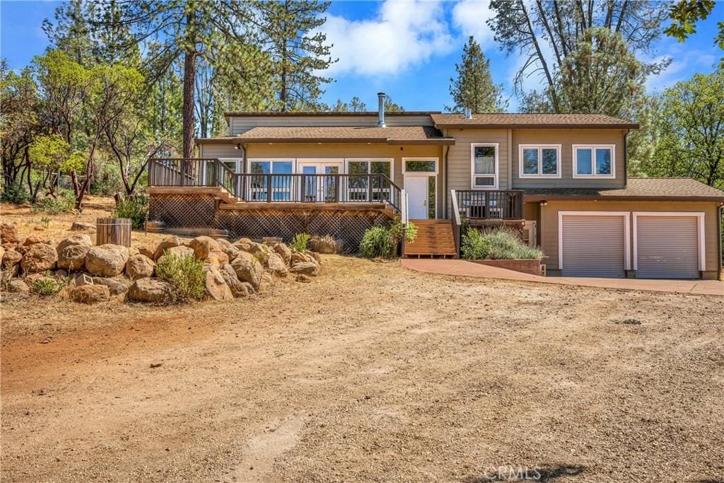 view of front of home with a garage and a deck