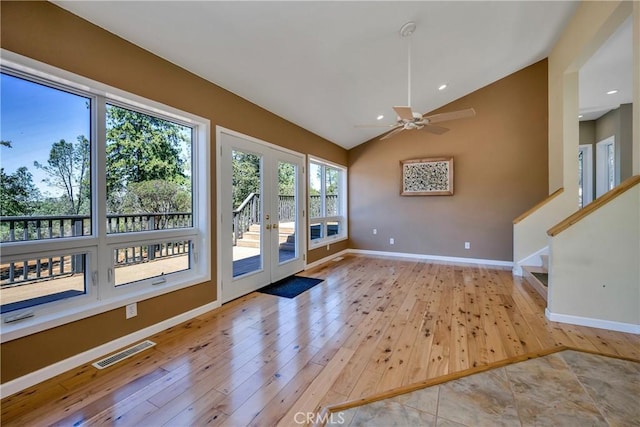 interior space with french doors, ceiling fan, light hardwood / wood-style flooring, and lofted ceiling