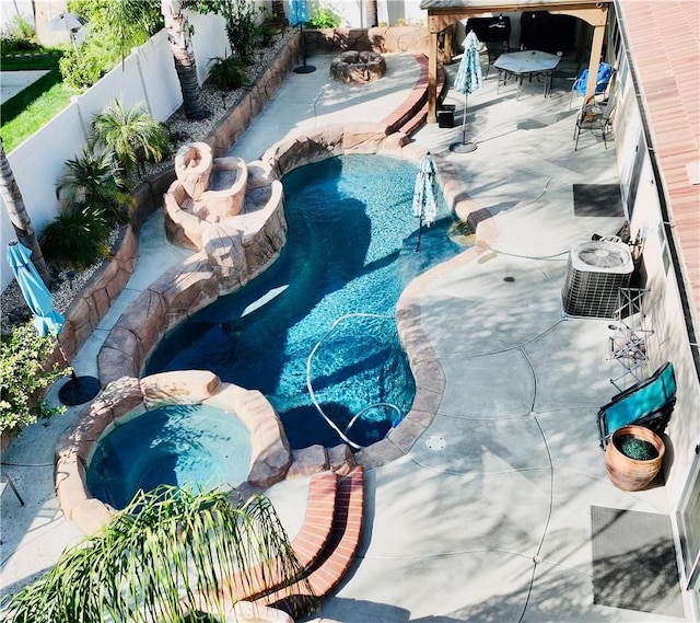 view of pool featuring an in ground hot tub and central AC