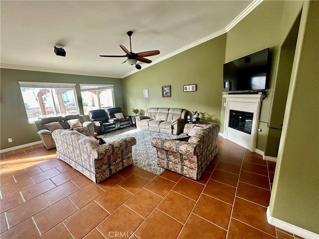 living room with ornamental molding, dark tile patterned flooring, ceiling fan, and lofted ceiling