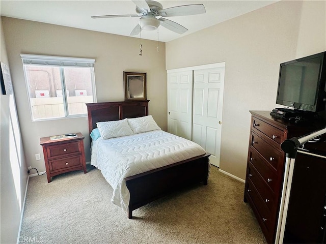 carpeted bedroom with a closet and ceiling fan