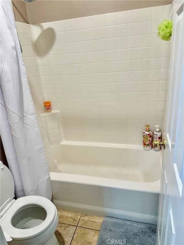 bathroom featuring tile patterned floors, shower / tub combo with curtain, and toilet