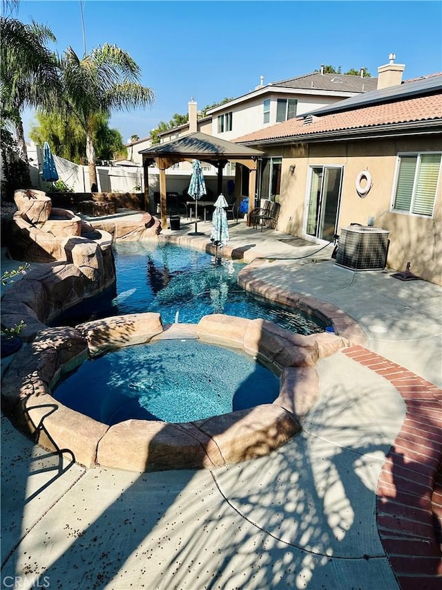 view of swimming pool with a gazebo, a patio area, central air condition unit, and an in ground hot tub