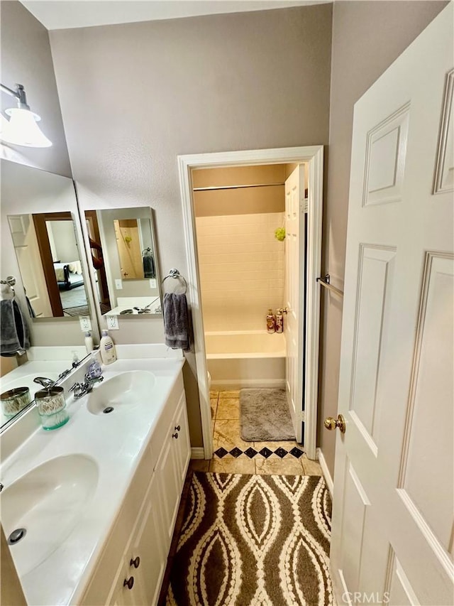 bathroom featuring tile patterned floors, vanity, and tiled shower / bath