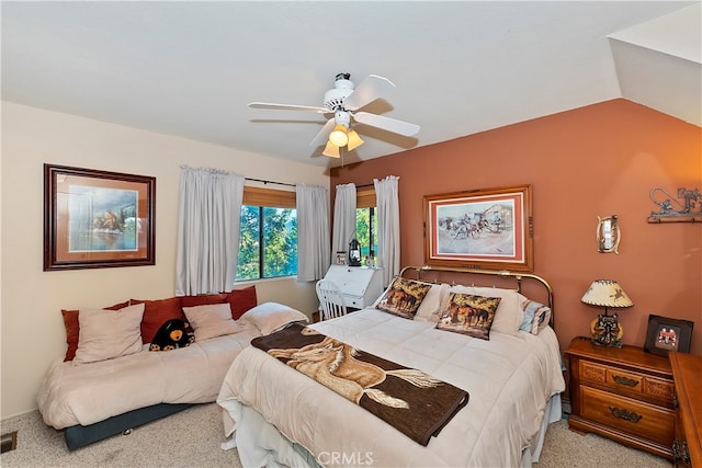 bedroom with ceiling fan, lofted ceiling, and light colored carpet