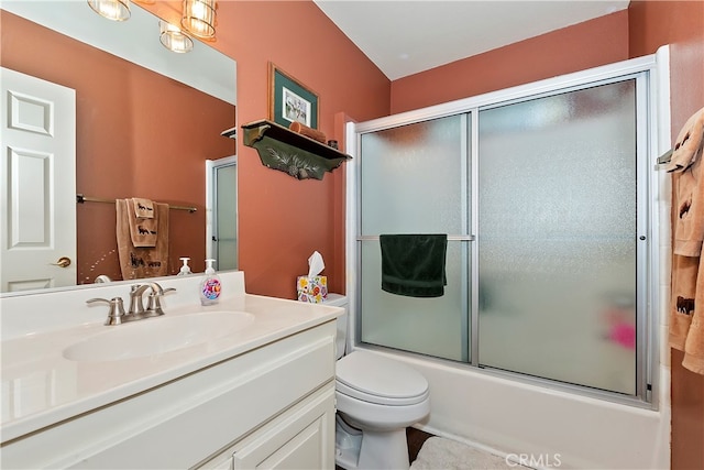 full bathroom with vanity, toilet, and shower / bath combination with glass door