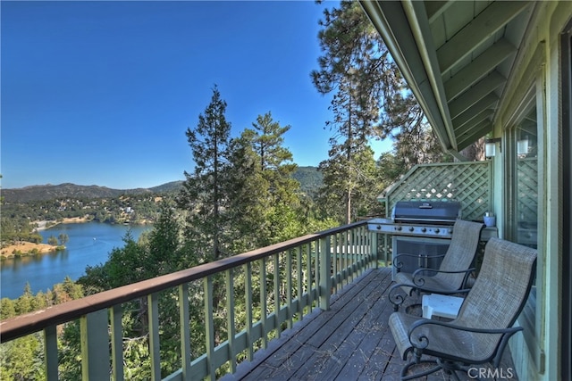 deck with a water view and grilling area