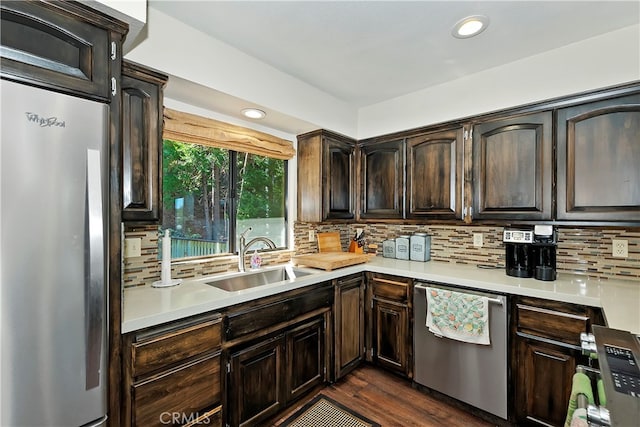 kitchen with backsplash, stainless steel appliances, and sink