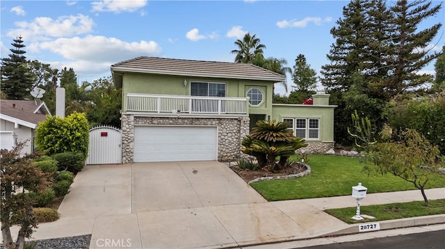 view of property featuring a front lawn and a garage