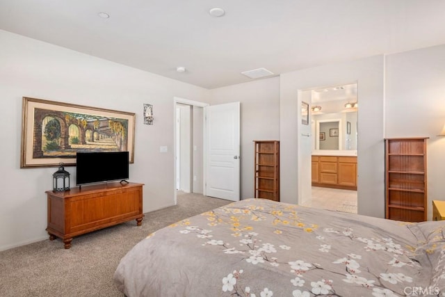 carpeted bedroom featuring ensuite bathroom