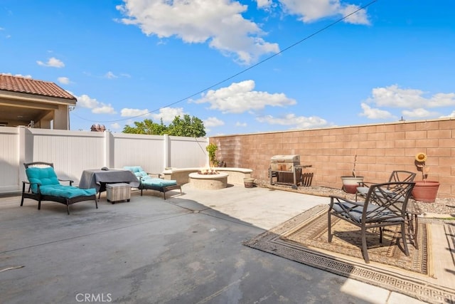 view of patio featuring a grill and a fire pit