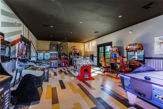 recreation room featuring hardwood / wood-style floors and crown molding