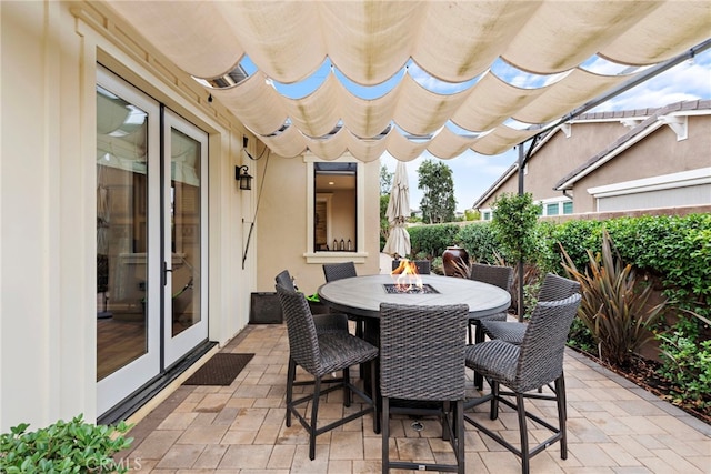 view of patio with french doors and an outdoor fire pit