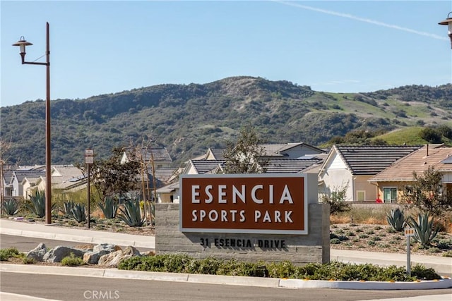 community / neighborhood sign with a mountain view