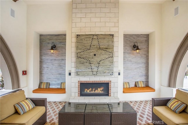 sitting room with a tile fireplace