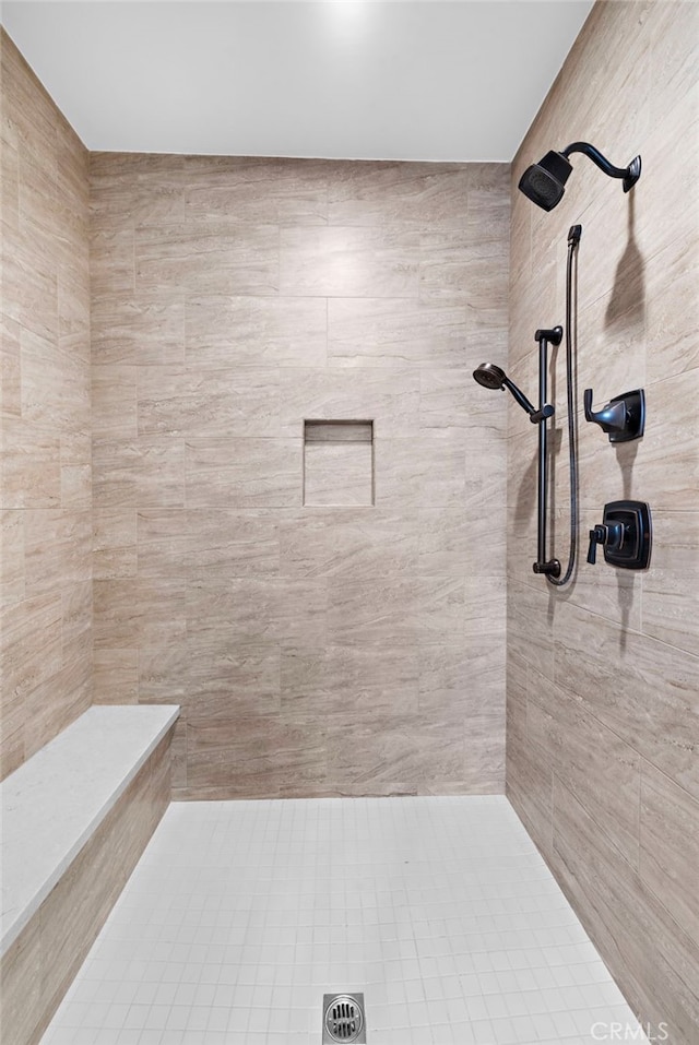 bathroom featuring a tile shower