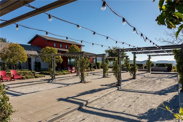 surrounding community with a pergola and a mountain view