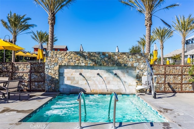 view of swimming pool featuring a patio area