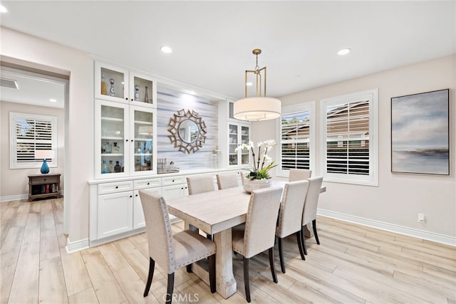 dining space with light hardwood / wood-style floors