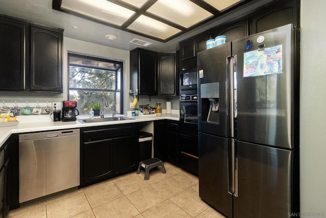 kitchen with sink, appliances with stainless steel finishes, and light tile patterned flooring