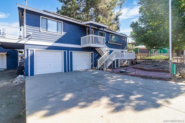 view of property with a garage and a balcony