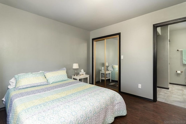 bedroom with a closet and dark wood-type flooring