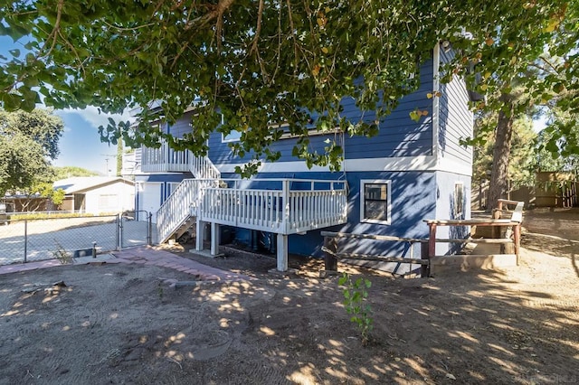 rear view of house with a wooden deck