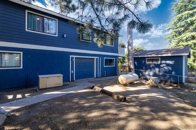 back of property with a garage