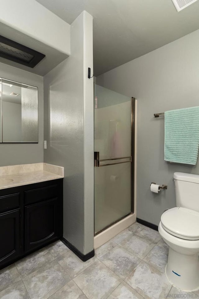 bathroom featuring vanity, toilet, and walk in shower