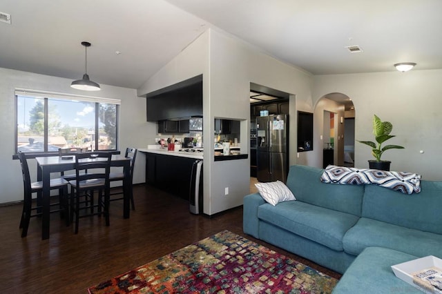 living room with vaulted ceiling and dark hardwood / wood-style floors