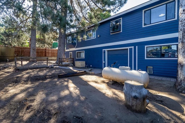 rear view of property with a garage