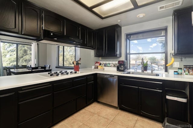 kitchen with white gas stovetop, dishwasher, light tile patterned flooring, and a wealth of natural light