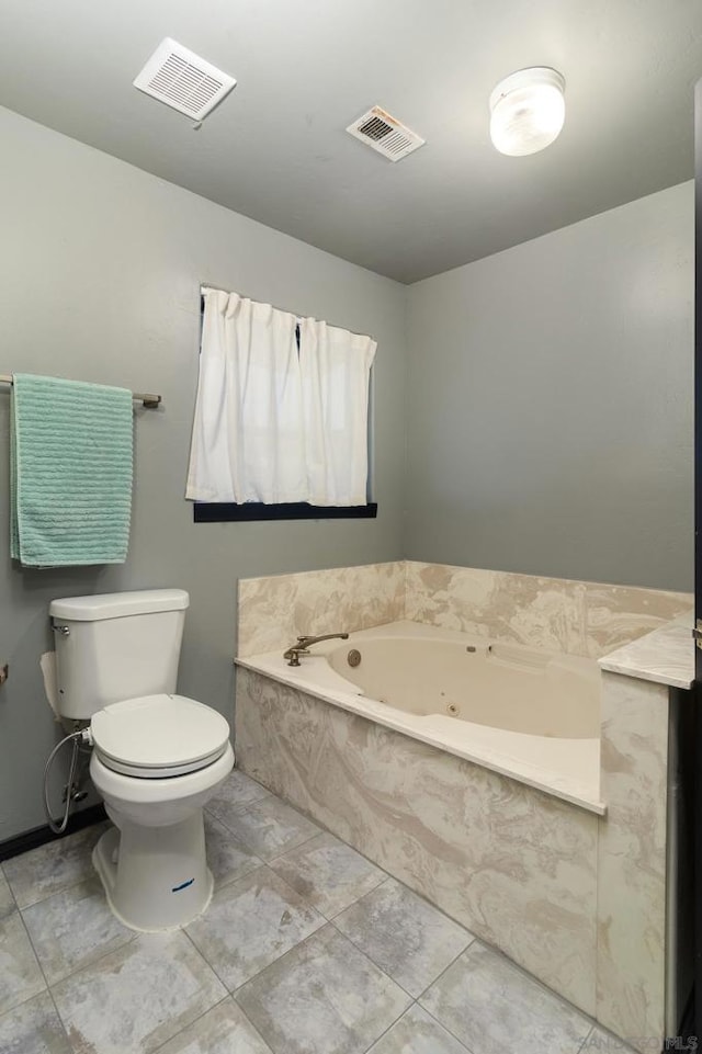 bathroom with a relaxing tiled tub and toilet