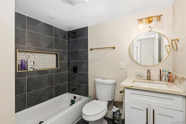 full bathroom featuring toilet, tiled shower / bath combo, and vanity