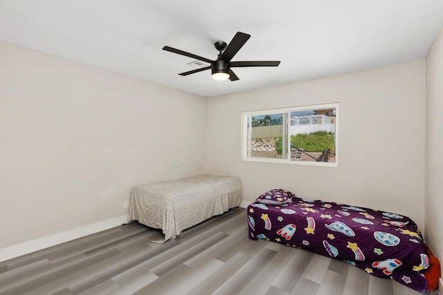 bedroom featuring hardwood / wood-style flooring and ceiling fan