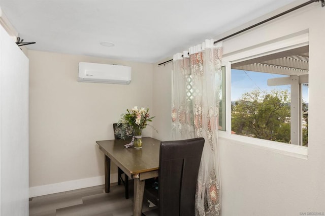 dining room with hardwood / wood-style floors and a wall mounted air conditioner