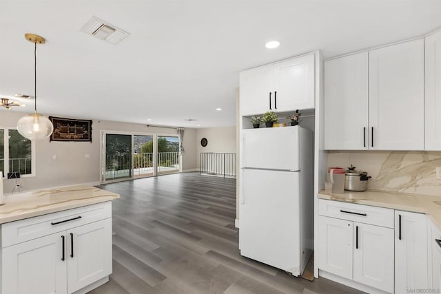 kitchen featuring white cabinets, white fridge, decorative light fixtures, and dark hardwood / wood-style flooring