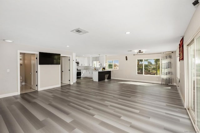 unfurnished living room with dark hardwood / wood-style flooring