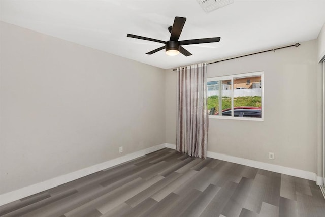 unfurnished room featuring ceiling fan and dark hardwood / wood-style flooring