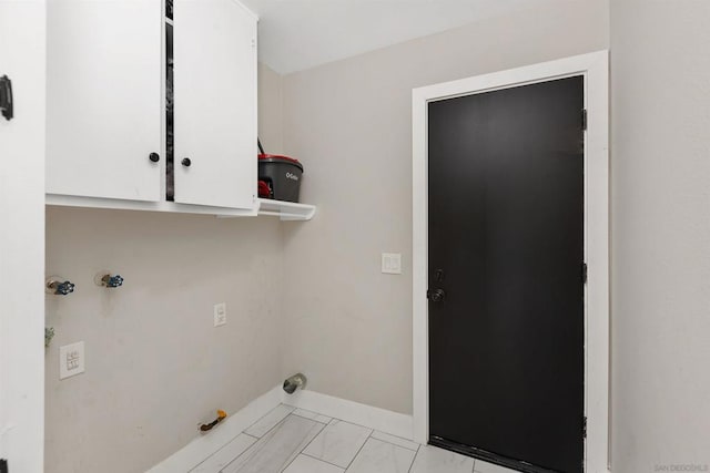 laundry area featuring hookup for a gas dryer, hookup for a washing machine, and cabinets