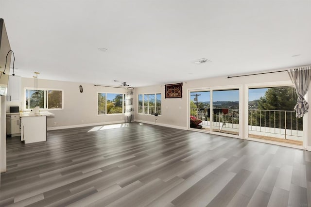 unfurnished living room with dark hardwood / wood-style floors