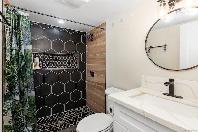 bathroom featuring vanity, curtained shower, and toilet